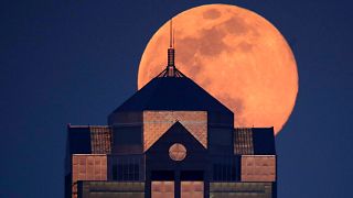 Last month's supermoon rising behind a downtown office building in Kansas City, Mo., Tuesday, April 7, 2020.
