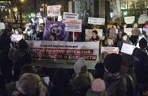 People hold banners against domestic violence attend a rally in Moscow's downtown, R on Monday, Nov. 25, 2019.ussia