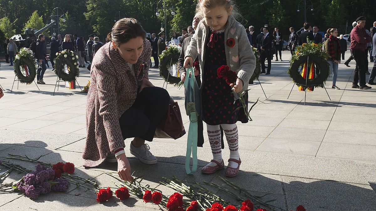 Four-year-old Emilia lays down flowers at Berlin's Soviet War memorial during commemorations to mark the 75th anniversary of Victory Day on May 8, 2020.