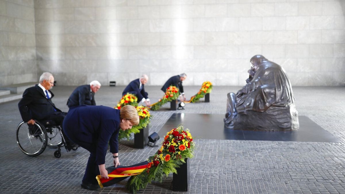 German Chancellor Angela Merkel and other officials lay wreaths at the Neue Wache Memorial in Berlin, Germany, May 8, 2020. 