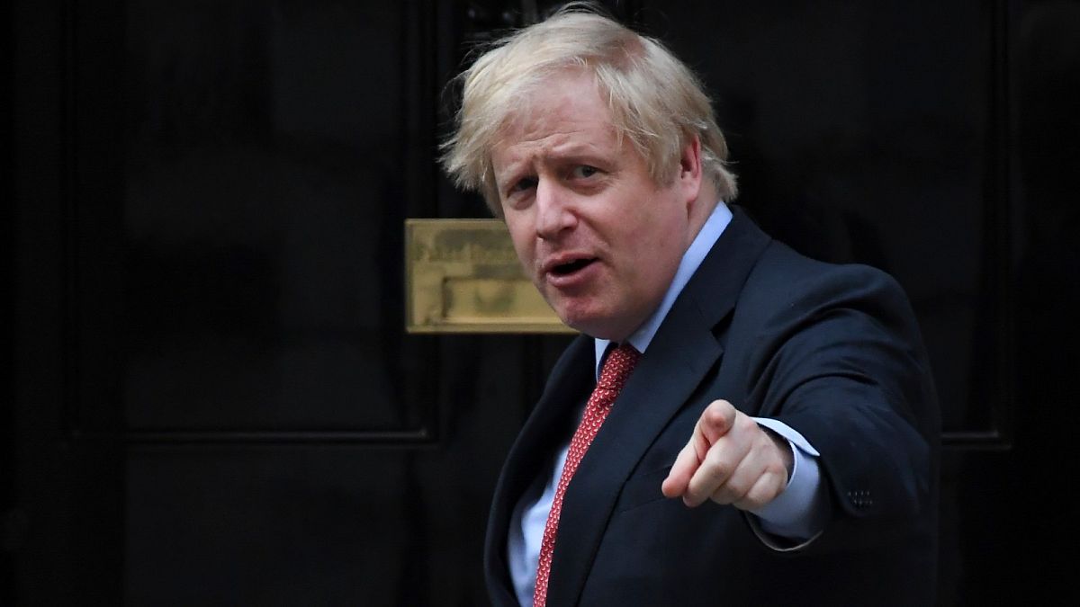 Britain's Prime Minister Boris Johnson joins in the applause on the doorstep of 10 Downing Street in London during the weekly "Clap for our Carers" Thursday, May 7, 2020