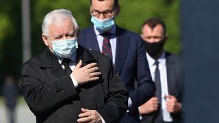 Poland's ruling party leader Jaroslaw Kaczynski, left, and Prime Minister Mateusz Morawiecki, center.