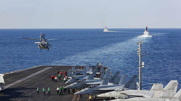 In this Tuesday, Nov. 19, 2019, photo made available by U.S. Navy, a helicopter lifts off of the aircraft carrier USS Abraham Lincoln as it transits the Strait of Hormuz. In this Tuesday, Nov. 19, 2019, photo made available by U.S. Navy, a helicopter lifts off of the aircraft carrier USS Abraham Lincoln as it transits the Strait of Hormuz.
