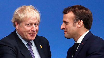 Britain's Prime Minister Boris Johnson (L) welcomes France's President Emmanuel Macron (R) London on December 4, 2019. (Photo by CHRISTIAN HARTMANN / POOL / AFP)
