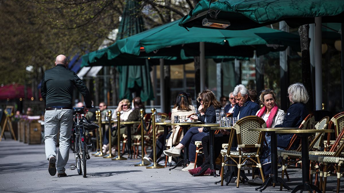 People sit in a restaurant in Stockholm on May 8, 2020, amid the coronavirus COVID-19 pandemic. (Photo by Jonathan NACKSTRAND / AFP)