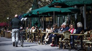 People sit in a restaurant in Stockholm on May 8, 2020, amid the coronavirus COVID-19 pandemic. (Photo by Jonathan NACKSTRAND / AFP)