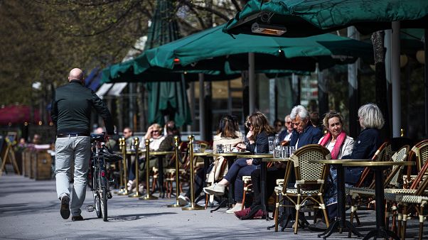 People sit in a restaurant in Stockholm on May 8, 2020, amid the coronavirus COVID-19 pandemic. (Photo by Jonathan NACKSTRAND / AFP) People sit in a restaurant in Stockholm on May 8, 2020, amid the coronavirus COVID-19 pandemic. (Photo by Jonathan NACKSTRAND / AFP)