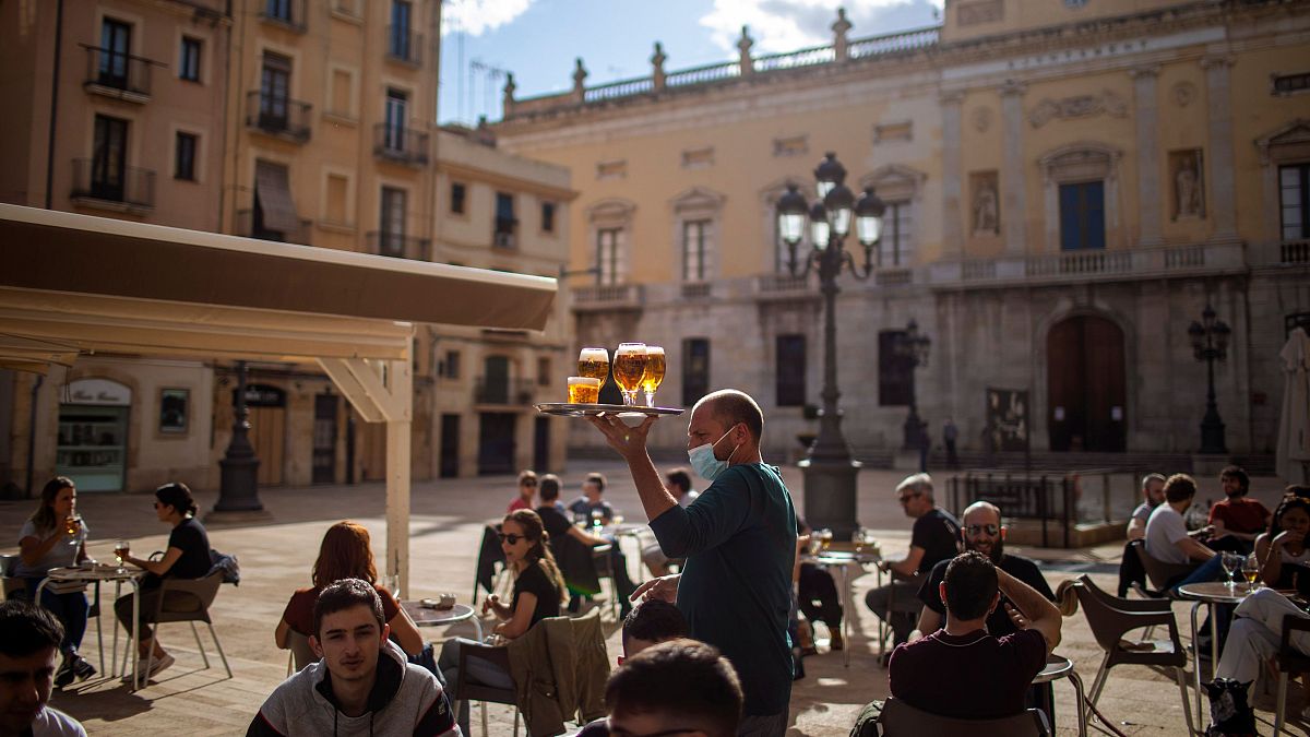 People enjoy drinks in Tarragona, Spain
