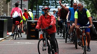 People cycle through Westminster area of London, Sunday, May 10, 2020 during the nation-wide coronavirus lockdown.