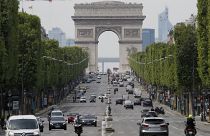 Cars drive on the Champs Elysee avenue in Paris.