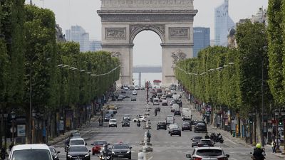 Cars drive on the Champs Elysee avenue, Thursday, May 7, 2020 in Paris. Cars drive on the Champs Elysee avenue, Thursday, May 7, 2020 in Paris.
