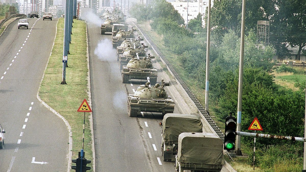 Tanks and jeeps of the Yugoslav Army cross a bridge on way back to the Marshal-Tito-Barracks in Zagreb on Wednesday, July 3, 1991. 