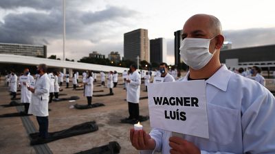 Brazilian nurses honour health workers who have died of the novel coronavirus COVID-19, during a demonstration in Brasilia.