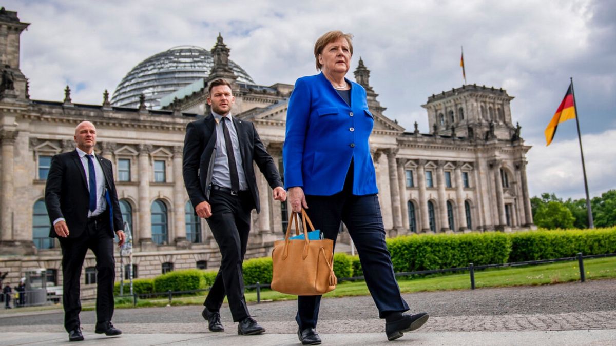 German Chancellor Angela Merkel walks to the Chancellery after the government questioning in the Bundestag in Berlin, Wednesday, May 13