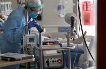 A nurse monitors a machine machine connected to a patient in the COVID-19 Intensive Care Unit at Harborview Medical Center Friday, May 8, 2020, in Seattle.
