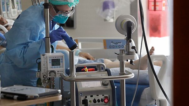 A nurse monitors a machine machine connected to a patient in the COVID-19 Intensive Care Unit at Harborview Medical Center Friday, May 8, 2020, in Seattle. A nurse monitors a machine machine connected to a patient in the COVID-19 Intensive Care Unit at Harborview Medical Center Friday, May 8, 2020, in Seattle.