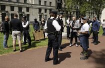 Police officers speak to people taking part in a coronavirus anti-lockdown, anti-vaccine, anti-5G and pro-freedom protest in London on May 2, 2020.