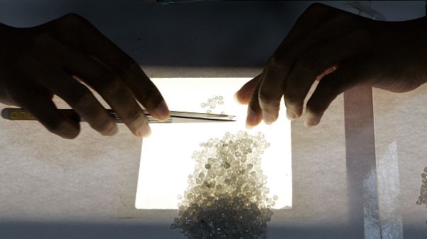 A worker sorts diamonds according their color (AP Photo/Themba Hadebe) A worker sorts diamonds according their color (AP Photo/Themba Hadebe)