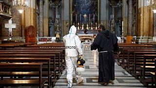 An Italian Army specialist talks with a priest in Rome