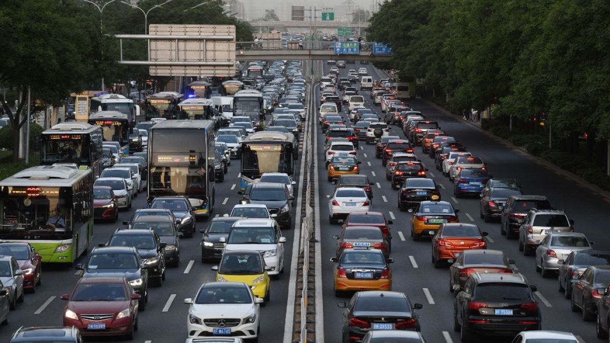 Cars are seen on a road in Beijing on May 12, 2020 (Photo by GREG BAKER / AFP)