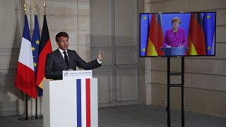 French President Emmanuel Macron speaks while German Chancellor Angela Merkel during a joint press conference on May 18, 2020.