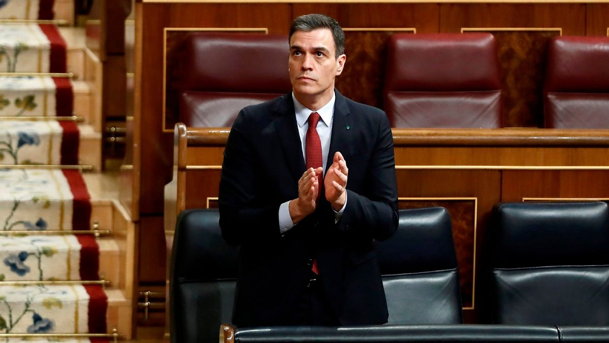 Spain's Prime Minister Pedro Sanchez applauds in parliament before a vote to approve the extension of the national lockdown in Madrid, Spain, Wednesday, March 25, 2020