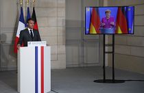 French President Emmanuel Macron listens to German Chancellor Angela Merkel during a joint video press conference Monday, May 18, 2020 in Paris. (AP/Francois Mori, Pool)