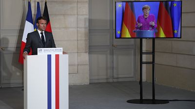 French President Emmanuel Macron listens to German Chancellor Angela Merkel during a joint video press conference Monday, May 18, 2020 in Paris. (AP/Francois Mori, Pool)
