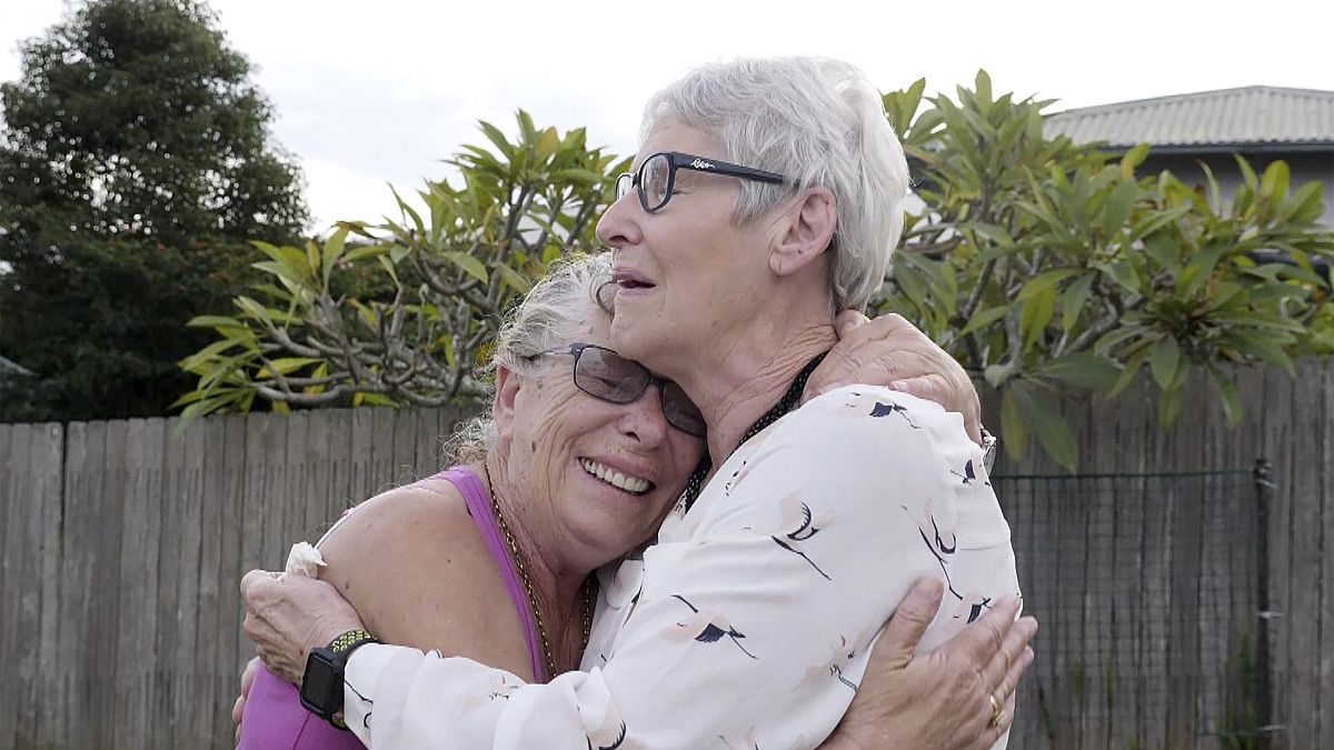 Christine Archer, right, and her sister Gail Baker cry as they are reunited in Bowraville, Australia 