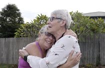 Christine Archer, right, and her sister Gail Baker cry as they are reunited in Bowraville, Australia