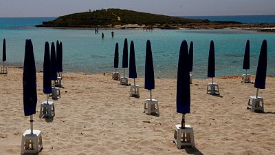 Rows of closed parasols on a nearly empty stretch of Nissi beach in Cyprus' seaside resort of Ayia Napa, a popular tourist destination, Wednesday, May 13 2020.