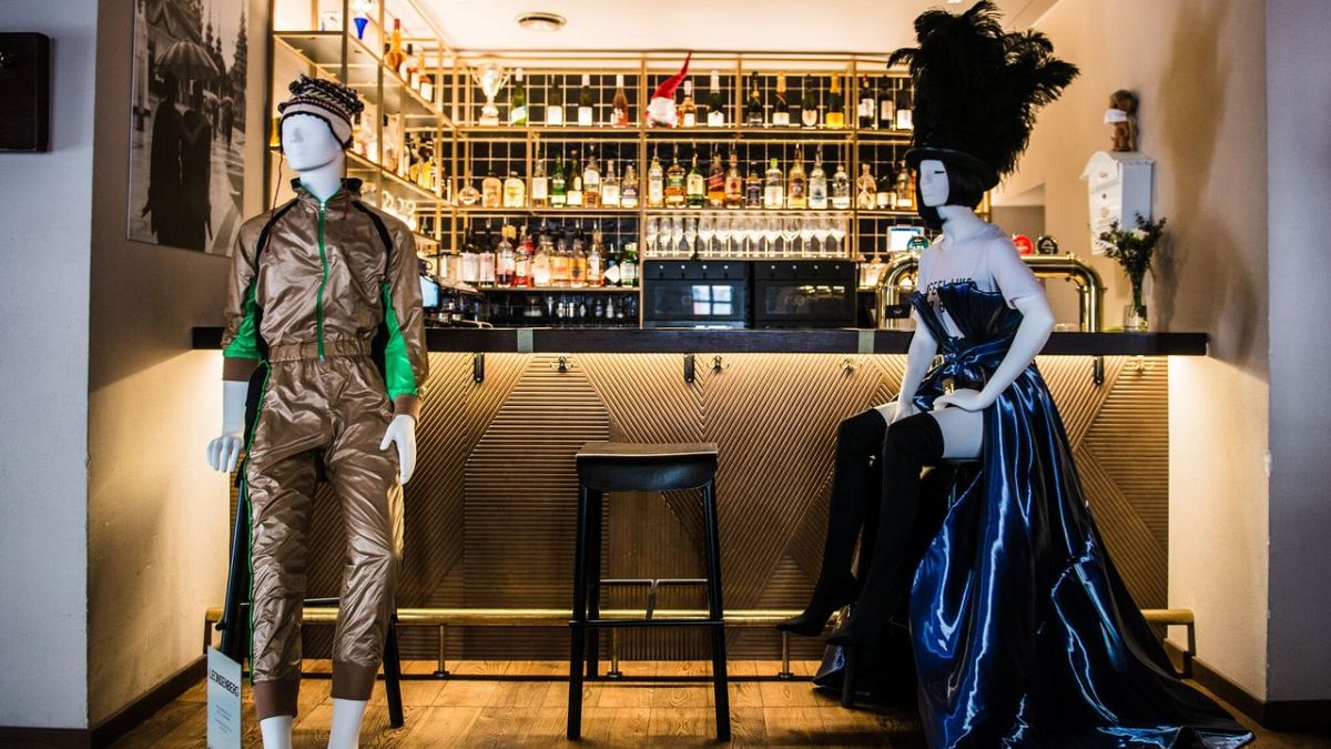 Mannequins showcase designers’ collections at restaurant “Cosy” in Vilnius Old Town.