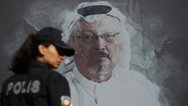 Wednesday, Oct. 2, 2019 file photo, a Turkish police officer walks past a picture of slain Saudi journalist Jamal Khashoggi near the Saudi Arabia consulate in Istanbul Wednesday, Oct. 2, 2019 file photo, a Turkish police officer walks past a picture of slain Saudi journalist Jamal Khashoggi near the Saudi Arabia consulate in Istanbul