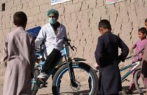 Afghan cyclist in 'door-to-door' campaign to curb virus spread
