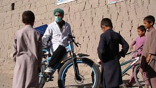 Afghan cyclist in 'door-to-door' campaign to curb virus spread