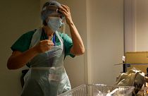 Nurse gets dressed in PPE, UK