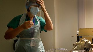 Nurse gets dressed in PPE, UK