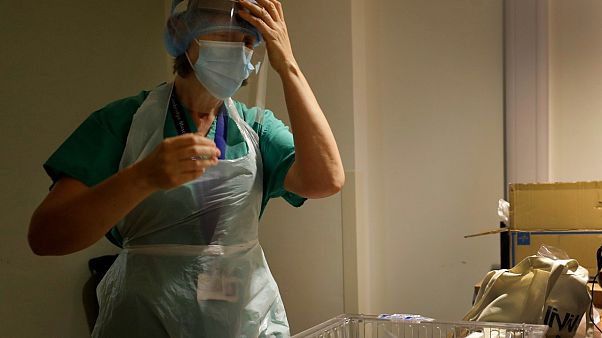 Nurse gets dressed in PPE, UK Nurse gets dressed in PPE, UK