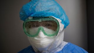 A woman looks at camera through her fogged up goggles in the intensive care unit for COVID-19, at the Guillermo Almenara hospital in Lima, Peru, Friday, May 22, 2020