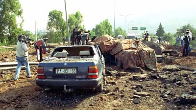 May 23, 1992 file photo shows the damage after a bomb blast killed anti-Mafia prosecutor Giovanni Falcone, his wife and three policemen
