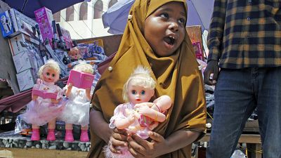 طفلة صومالية تحمل لعبة اشترتها بمناسبة العيد، مقديشيو الصومال. 