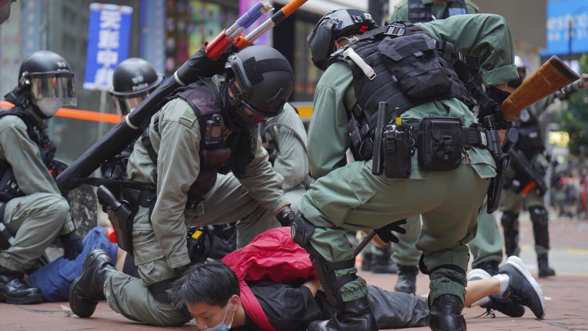 Riot police detain a protester during a demonstration against Beijing's national security legislation in Causeway Bay in Hong Kong