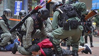 Riot police detain a protester during a demonstration against Beijing's national security legislation in Causeway Bay in Hong Kong