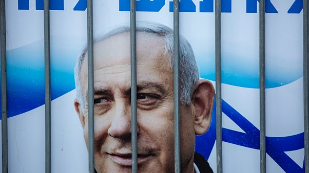 İsrail Başbakanı Netanyahu'nun posteri kendisini desteklemek için taraftarlarınca yapılan gösteride parmaklıklar arasında İsrail Başbakanı Netanyahu'nun posteri kendisini desteklemek için taraftarlarınca yapılan gösteride parmaklıklar arasında