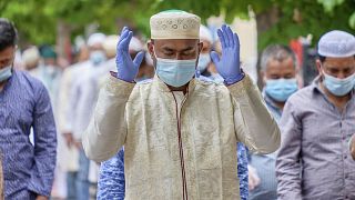 Muslims wearing gloves and face masks to prevent the spread of coronavirus attend prayers for Eid al-Fitr, the feast of breaking the fast that ends Ramadan.