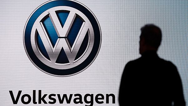 n this Wednesday, Nov. 28, 2018 file photo an attendee waits for the start of a news conference at the Volkswagen booth at the Los Angeles Auto Show. n this Wednesday, Nov. 28, 2018 file photo an attendee waits for the start of a news conference at the Volkswagen booth at the Los Angeles Auto Show.