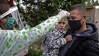 A health worker takes the temperature to a resident of Altos de San Lorenzo neighbourhood, near the city of La Plata, Argentina