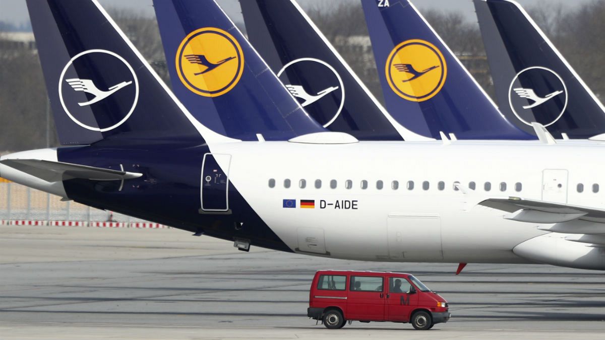 German Lufthansa planes sit parked in a line at the airport in Munich