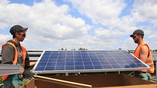 Workers install solar panels at the Constantine photovoltaic power station in Cestas, near Bordeaux, southwestern France, Friday, May 22, 2015.