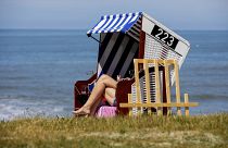 A woman is sunbathing on a beach chair by the sea in Norderney, Lower Saxony, Germany Tuesday May 26, 2020